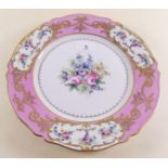 A French porcelain plate painted reserves of flowers on a pink ground, marked Paris