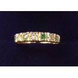 A 9 carat gold emerald and chip diamond set ring - size M