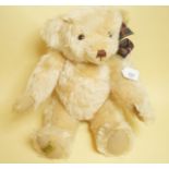A Merrythought blond and mohair bear with ribbon