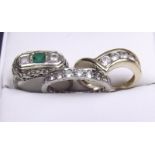 A 14 carat gold ring set white stones size L, a 9 carat gold eternity ring size N and an emerald and
