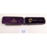 A 9 carat gold horseshoe and crop riding stock pin in original case