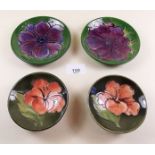 Four Moorcroft pin dishes in clematis and hibiscus patterns