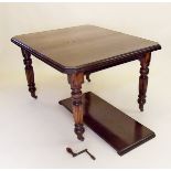 A Victorian mahogany finish wind out dining table with one interleaf all on turned and reeded