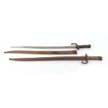 Two Chassepot bayonets with brass grips and metal scabbards