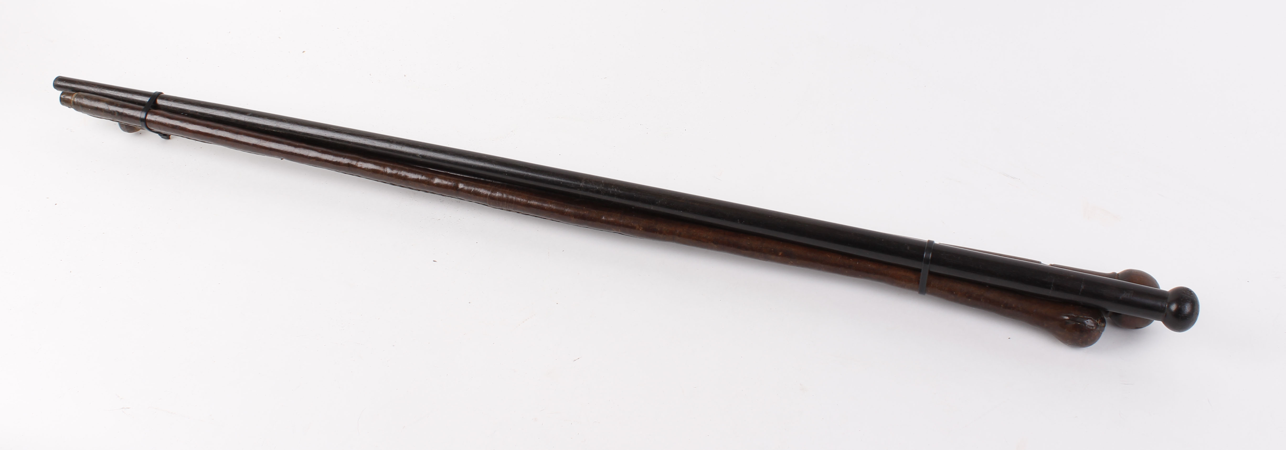 Leather covered cane; ebony and turned mahogany walking canes