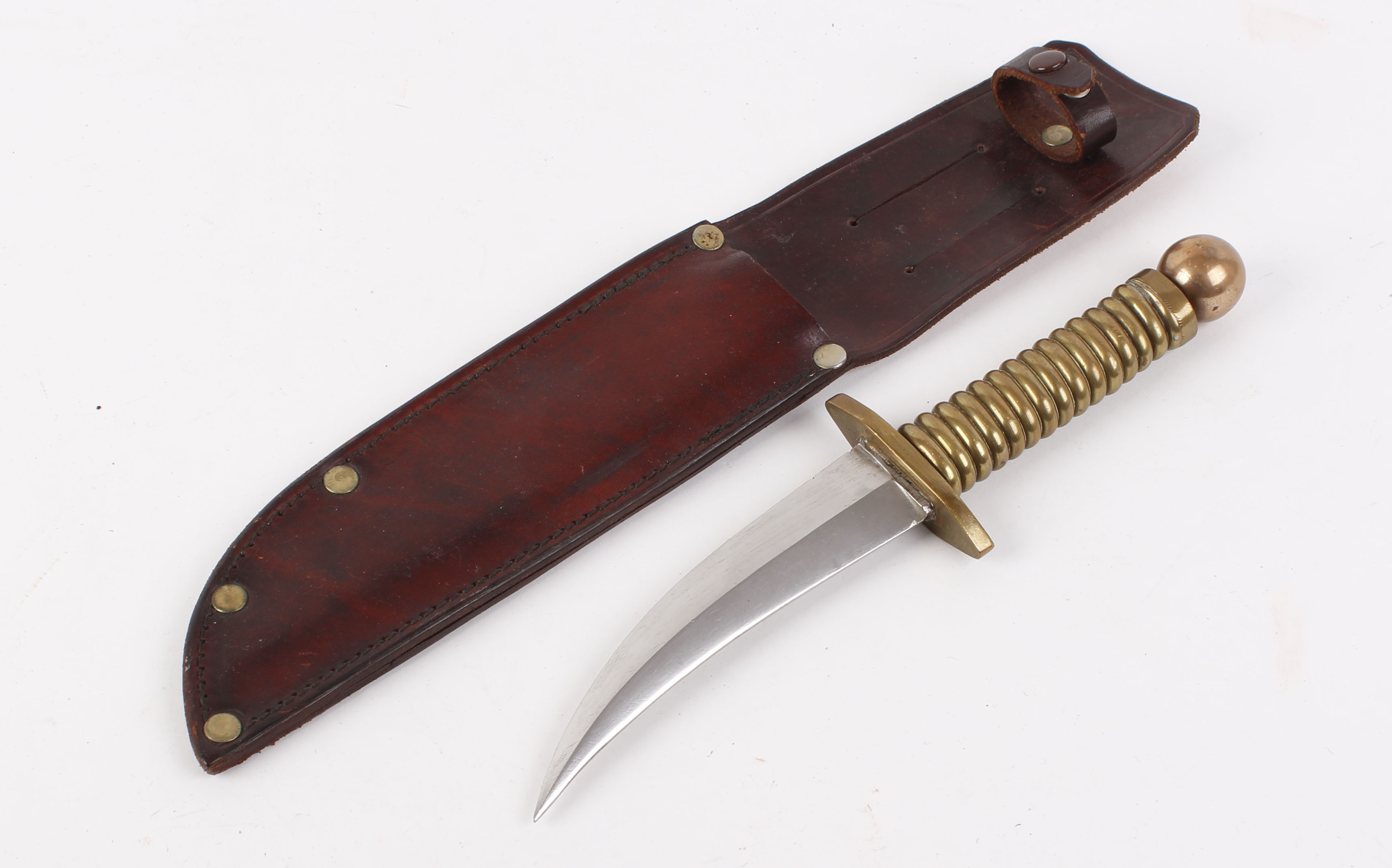 Jambiya type dagger, 5,1/2 ins curved double edged blade, brass quillon, grips and pommel, in red