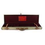 Canvas and leather gun case, claret baize lined fitted interior for up to 30,1/2 ins barrels,