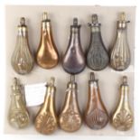 Ten copper and brass embossed decorated powder flasks by Sykes, Hawksley and others