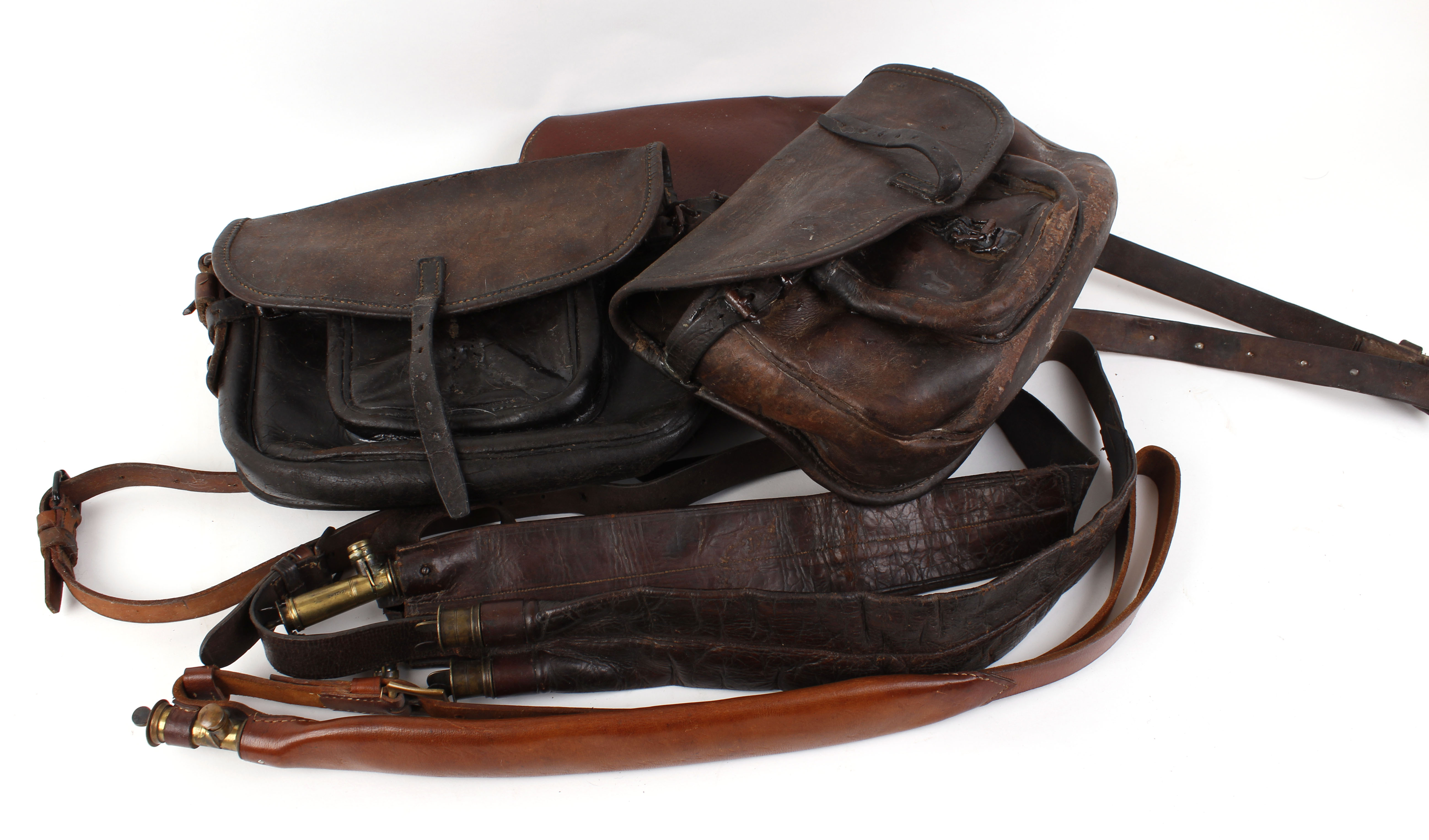 Two large leather Continental cartridge bags; canvas and leather game bag;