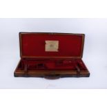 Oak and leather double gun case, brass mounted with red baize lined fitted interior for up to 30 ins