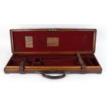 Oak and leather gun case, brass mounted, red baize lined fitted interior for up to 30 ins barrels,