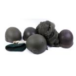 Four various military helmets and mosquito net