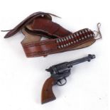 Western holster rig: leather belt and holster, with two replica Peacemaker revolvers. This Lot is