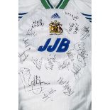 Wigan FC shirts, four, one with twenty autographs on white/blue/green (JJB) plus white/green (JJB)