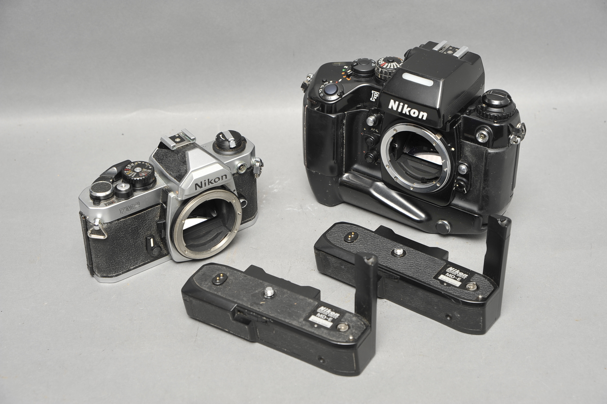 A Nikon F4 SLR Body, together with a FM2n and two MD-E grips (a lot)