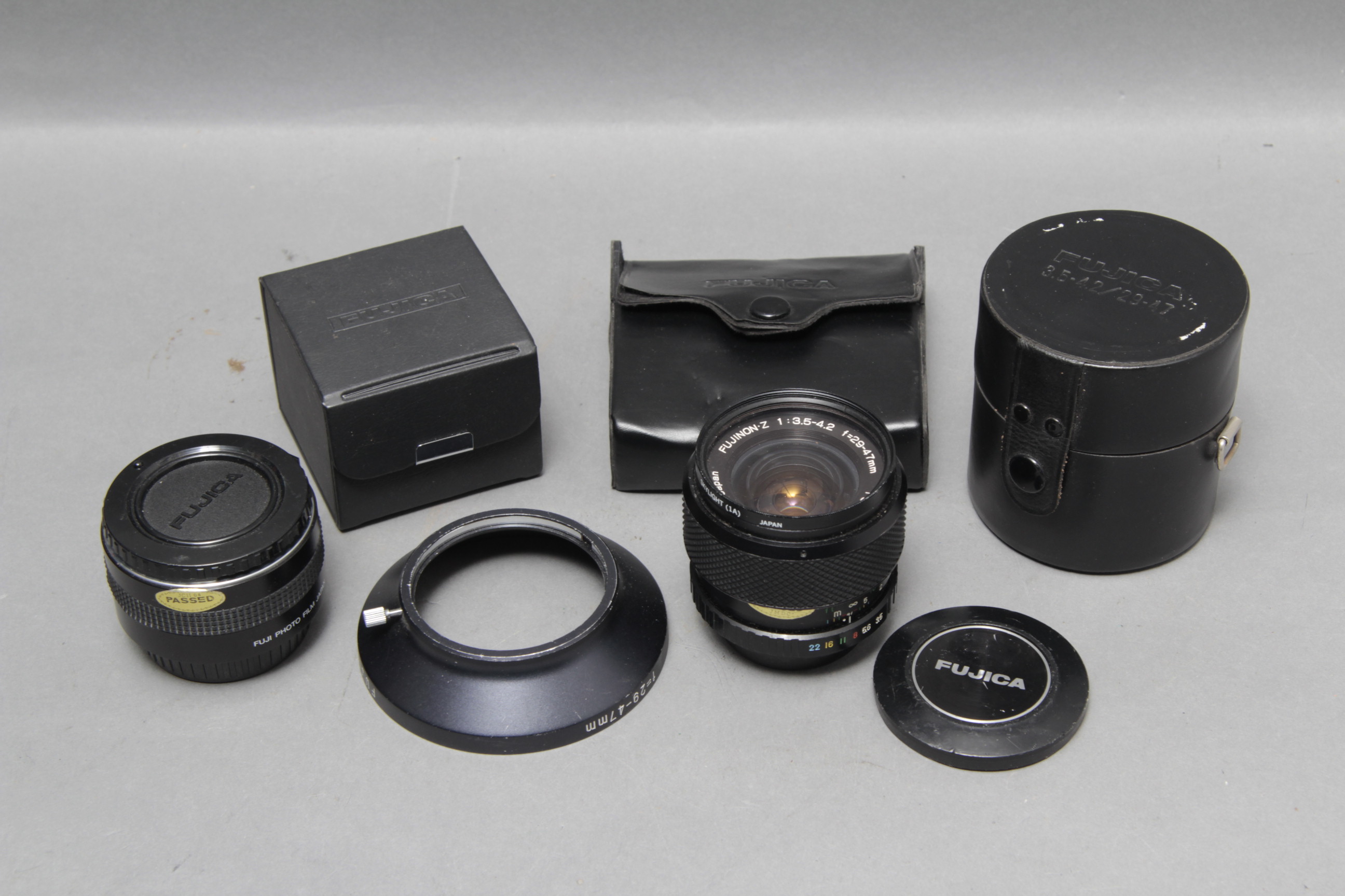 A Fujica Fujinon=z f/3.5-4.2 29-47mm Lens, complete with lens hood and teleconverter, all in maker's