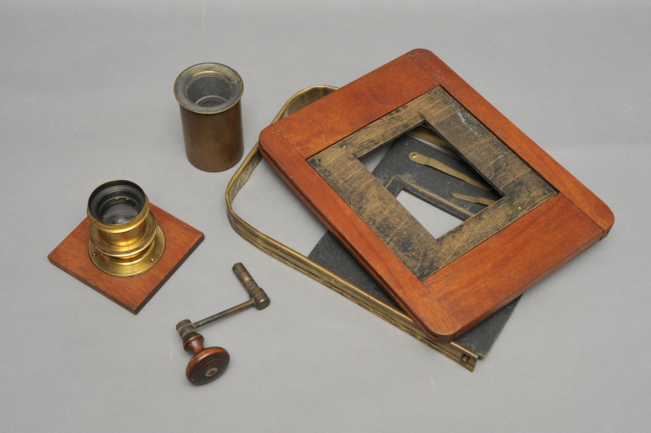 A Selection of Mahogany & Brass Camera Parts, including Underwood brass lens, together with a