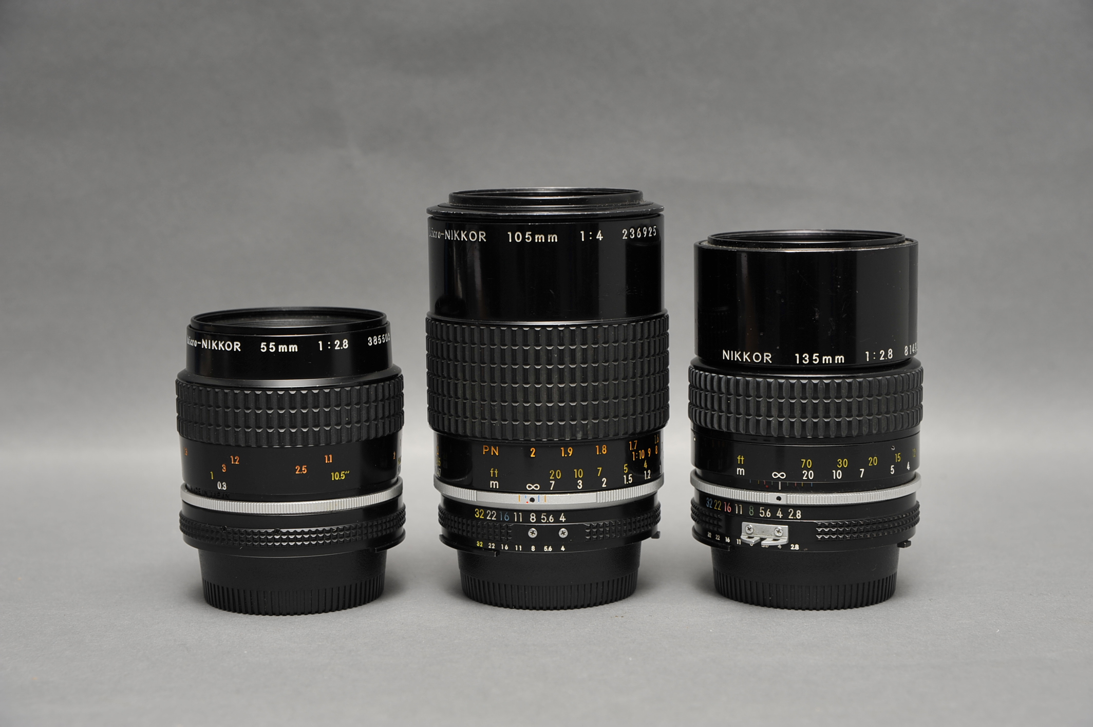 Three Nikkor Lenses, including f/2.8 55mm, f/4 105mm and f/2.8 135mm (3)