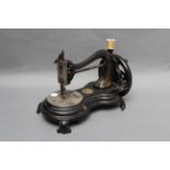 A Jones Hand Lockstitch Sewing Machine, with fiddle pattern base and with some gilt decoration,