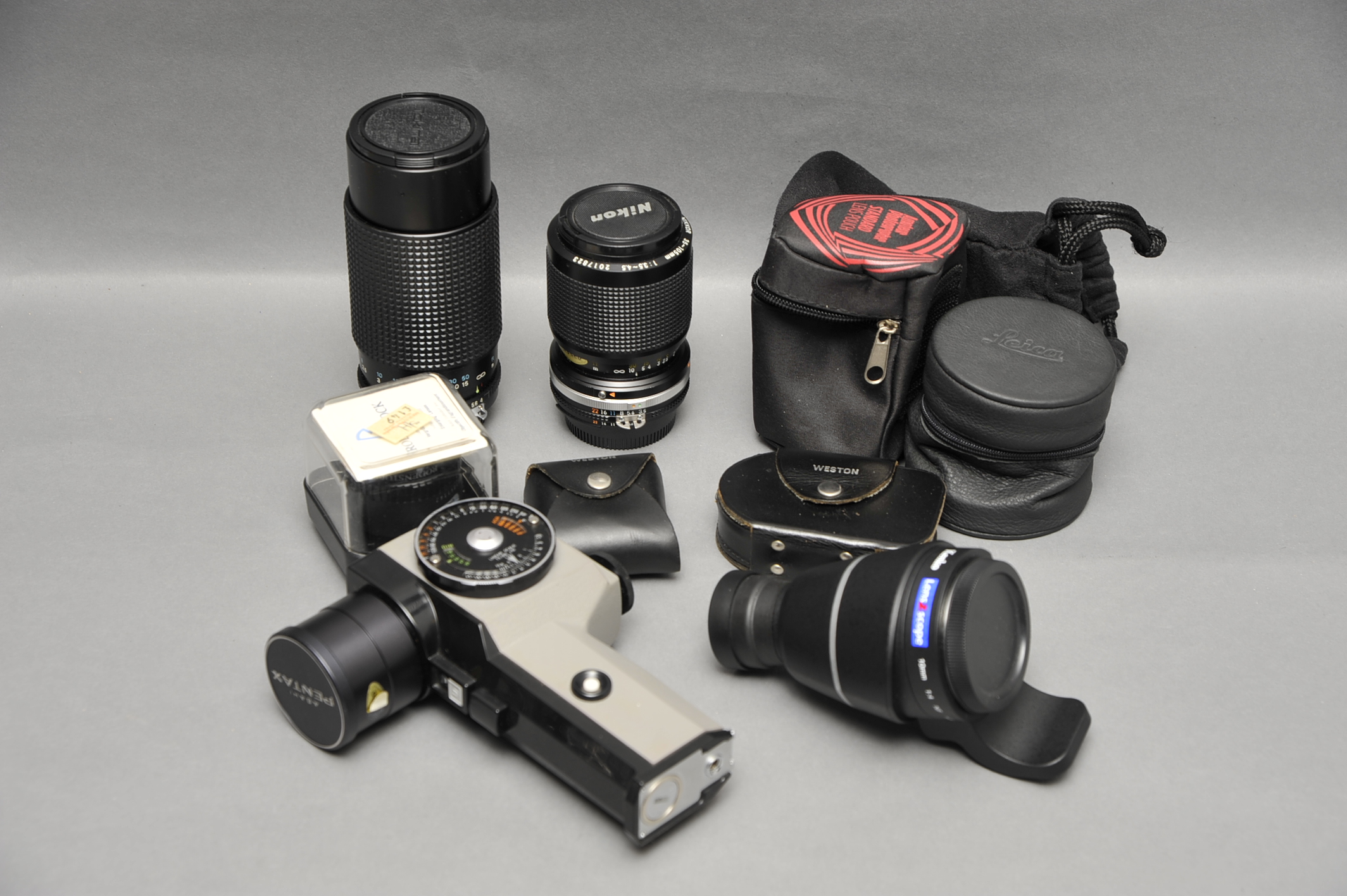 A Small Selection of Various Accessories, including Pentax Spotmeter, Nikkor lens, Leica case and