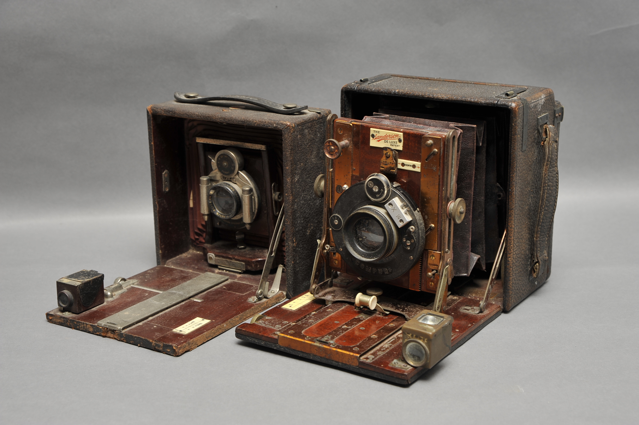 A Sanderson De Luxe Hand & Stand Camera, lacking back, together with a Rochester Optical Co. Pony