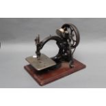 A Willcox & Gibbs Chain Stitch Sewing Machine, on mahogany base