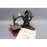 A Willcox & Gibbs Chain Stich Sewing Machine, on mahogany base, lacking reel holder, together with