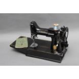 A Singer Featherweight 221K Sewing Machine, complete with various accessories, instructions,