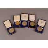 A collection of silver medals, silver gilt medals, a bronze medal, and two commemorative crowns (9)