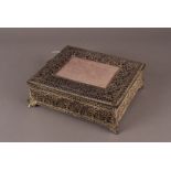 A fine filigree white metal eastern jewellery casket, with purple velvet lining 25.5 cm W