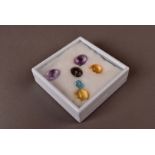 A collection of mixed gemstones, including amethysts, citrines, smoky quartz and others, total