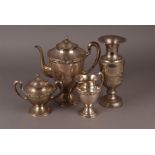 A small collection of silver plated ware, including a three piece coffee set, flatware, and more (