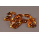 An Baltic amber necklace, the rough shaped beads, strung with three spacers 61g