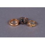 An 18 ct gold wedding band, 7.5g, a star sapphire 18 ct gold cluster ring 4.2 g, and another ring