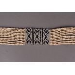 A Butler & Wilson 11 string faux pearl choker, with paste set clasps, stones missing 46 cm L, in