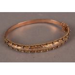 A 9 ct gold bangle, with raised beadwork and rope edging 8.4 g, in jeweller's box