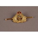 An Edwardian period 15ct gold sweetheart brooch, the bar brooch mounted with an RNR crest below