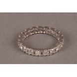 A modern white metal and diamond full eternity ring, set with eight cuts stones, approx 3.7g and