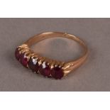 A vintage gold and five stone garnet ring, approx 3.2g and size P, presented in a vintage Cartier