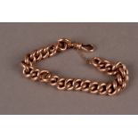 A late Victorian yellow metal bracelet, the large hollow curb link chain with watch snap clasp,