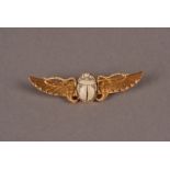 A vintage Middle Eastern gold winged scarab brooch, with chased wings centred by a carved