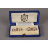 A fine pair of 18ct gold and mother of pearl cufflinks, modelled as buttons with twist edges and