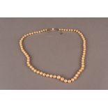 An Art Deco period pearl necklace with a diamond set clasp, the graduating pearls with nice lustre