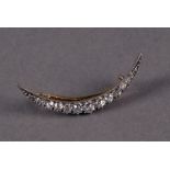 An Edwardian period diamond brooch from Mappin & Webb, the gold and silver crescent shaped mount set