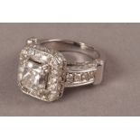 A modern impressive 14ct white gold and diamond engagement ring, the heavy diamond encrusted mount