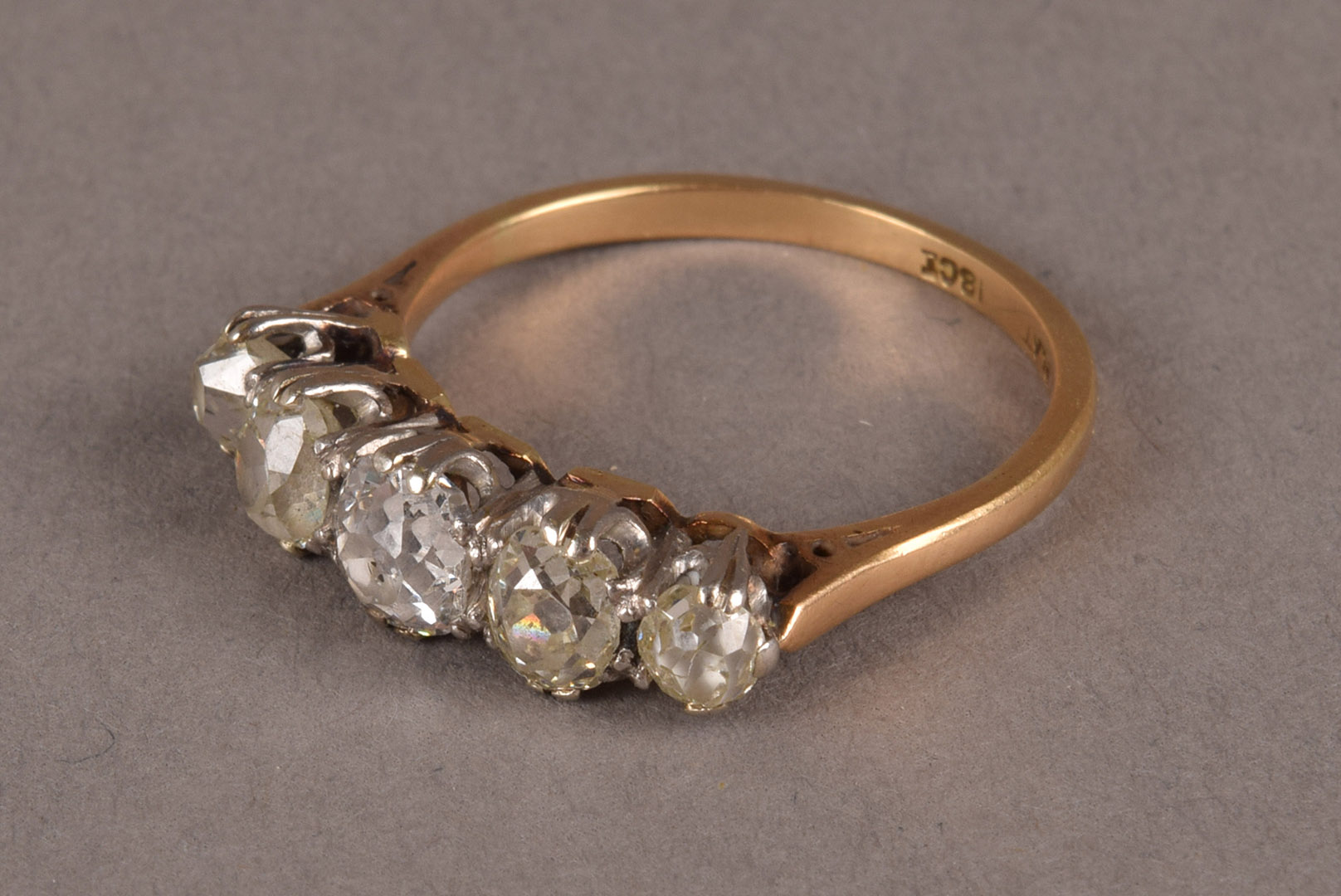 A late Victorian or Edwardian period five stone diamond engagement ring, having graduating old