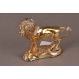 A modern South African silver gilt figure of a lion, filled, on base bearing strike marks, 10cm
