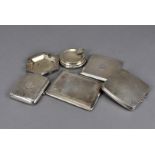 A collection of silver cigarette cases, including three engine turned examples, another curved