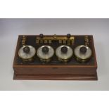 An H Tinsley & Co lacquered and silvered brass Four Dial Switch Bridge, in mahogany case, 580mm