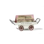 A Märklin Gauge 1 Platform Newspaper Barrow, in white with red wheels and blue lining to tray,